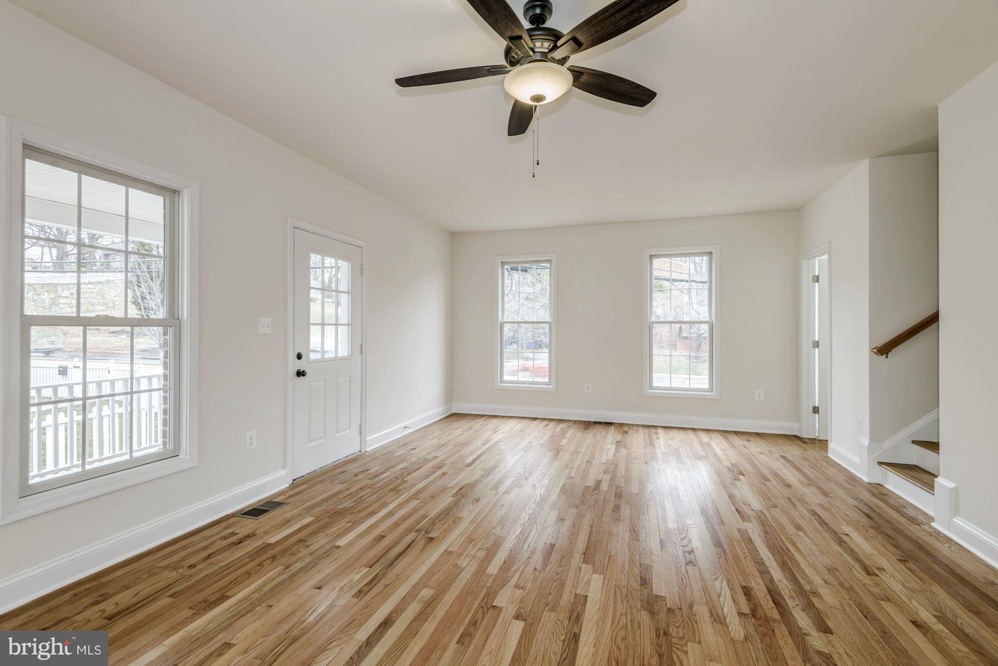 2016 South Glebe Road Arlington, VA 22204 - Photo 6 of 27 a view of an empty room with a window and wooden floor