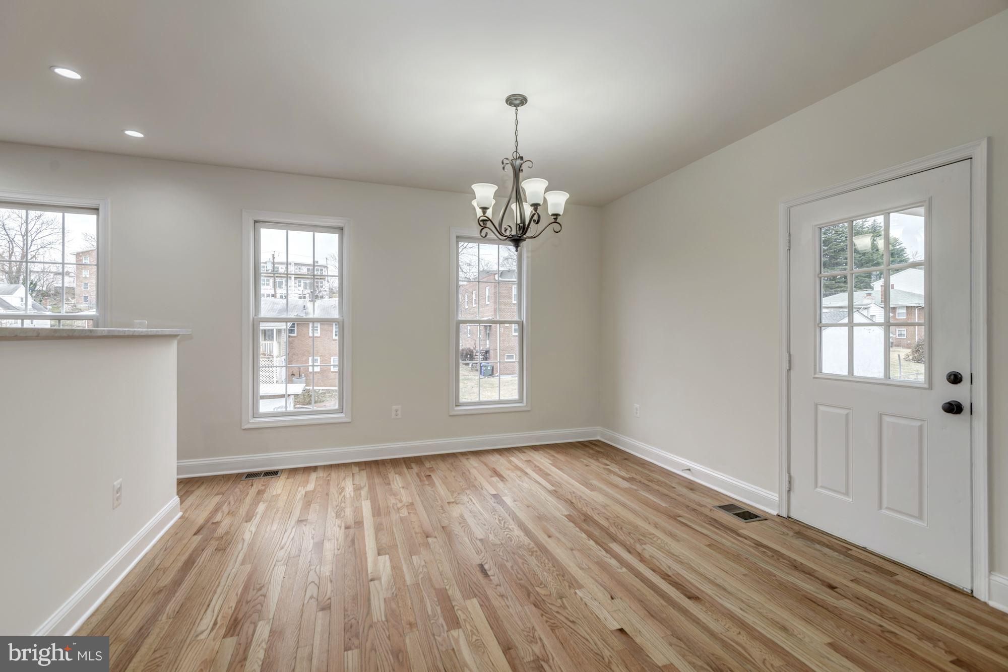 2016 South Glebe Road Arlington, VA 22204 - Photo 7 of 27 an empty room with wooden floor and windows
