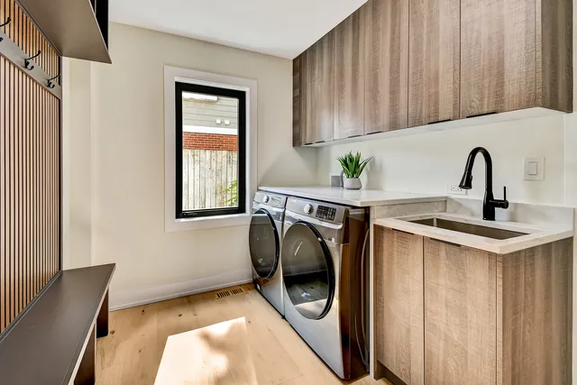 a kitchen with a sink a washer and dryer next to a window
