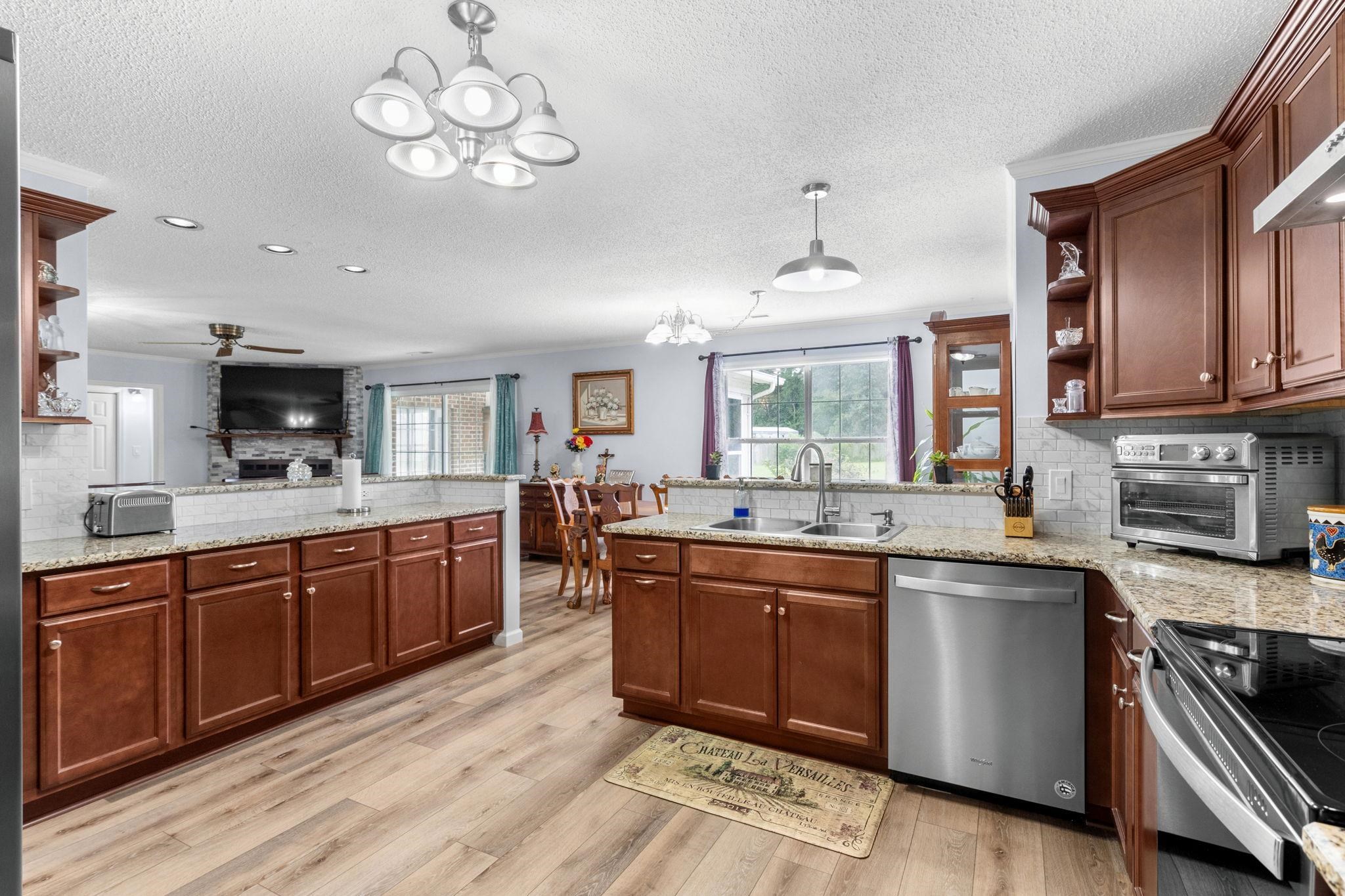 2981 Victor Road Longs, SC 29568 - Photo 16 of 32 Kitchen featuring open shelves, a peninsula, tasteful backsplash, a chandelier, and dishwasher