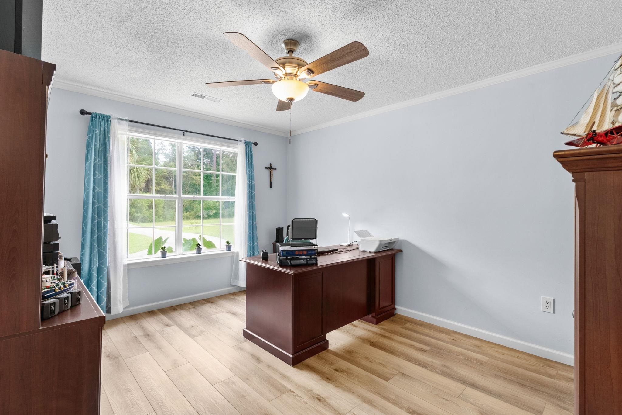 2981 Victor Road Longs, SC 29568 - Photo 21 of 32 Office area with light wood-type flooring, crown molding, a ceiling fan, and a textured ceiling