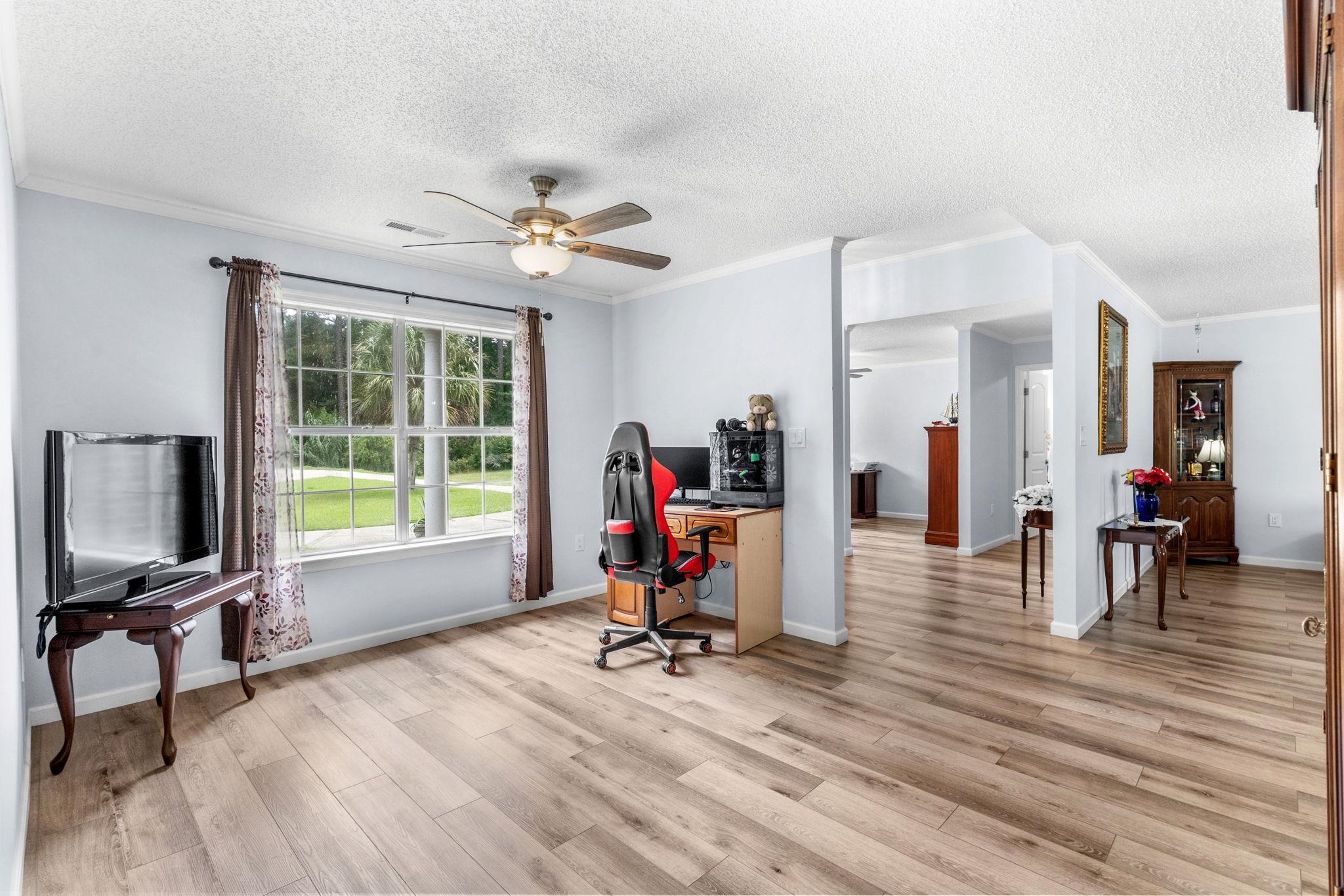 2981 Victor Road Longs, SC 29568 - Photo 22 of 32 Office area with crown molding, light wood-type flooring, a textured ceiling, and ceiling fan