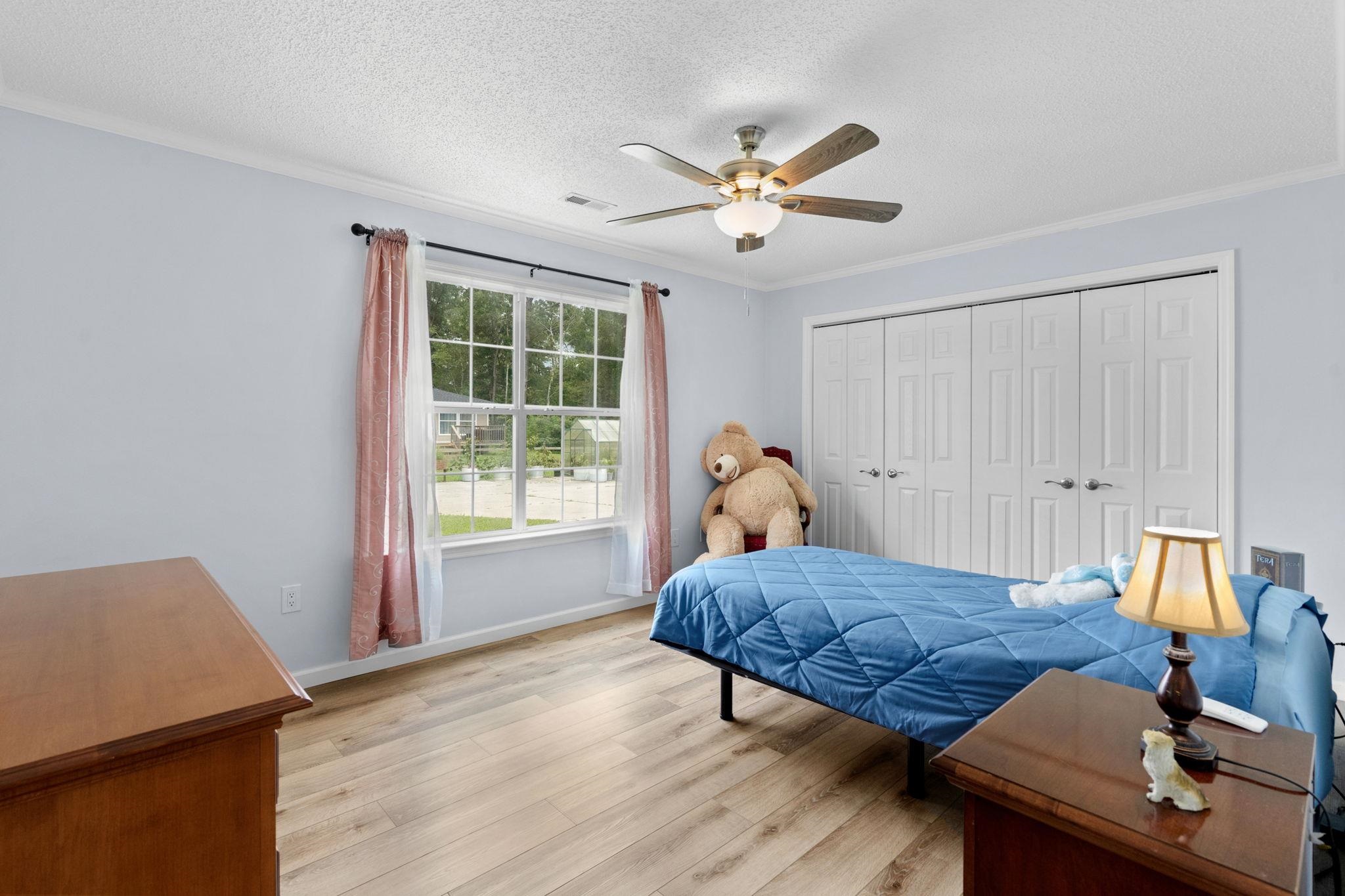 2981 Victor Road Longs, SC 29568 - Photo 24 of 32 Bedroom with light wood finished floors, ornamental molding, a closet, ceiling fan, and a textured ceiling
