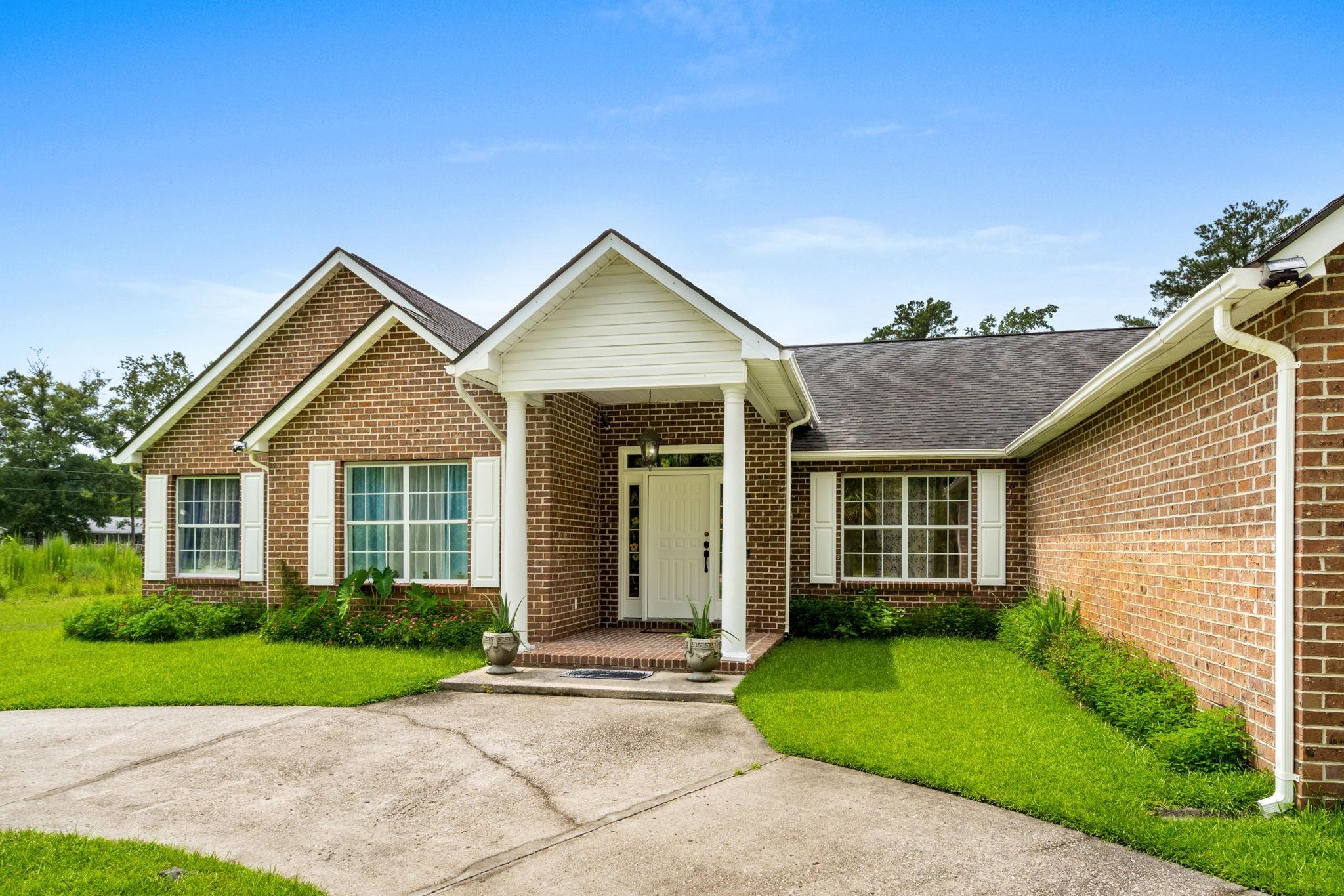 2981 Victor Road Longs, SC 29568 - Photo 3 of 32 View of front facade with a shingled roof, brick siding, and a front yard