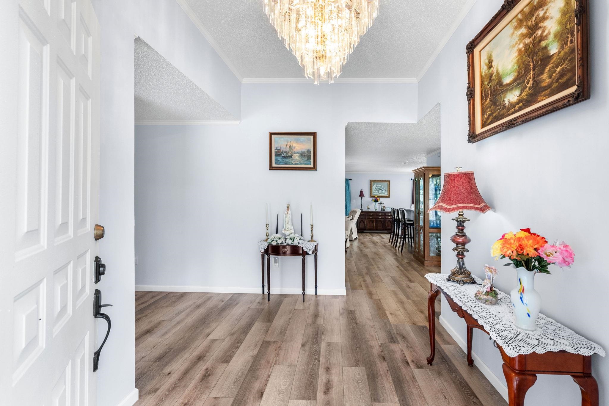 2981 Victor Road Longs, SC 29568 - Photo 5 of 32 Hall featuring wood finished floors, a chandelier, ornamental molding, and a textured ceiling