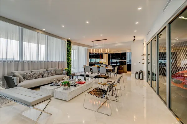 a living room with furniture and a view of kitchen
