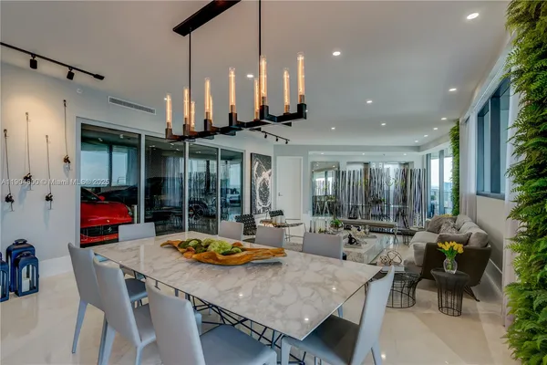 a kitchen with stainless steel appliances a dining table and chairs