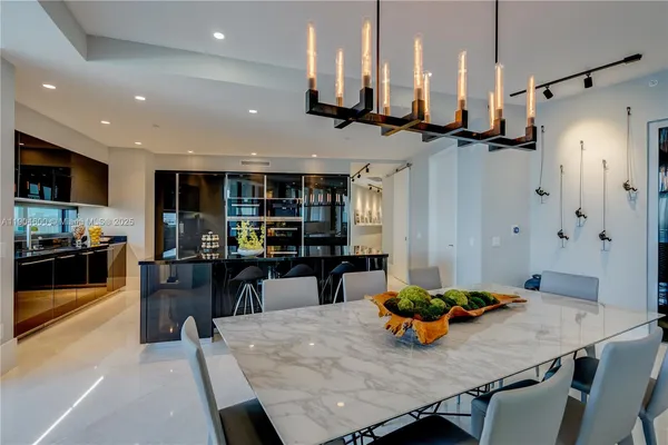 a dining room with furniture a chandelier and wooden floor