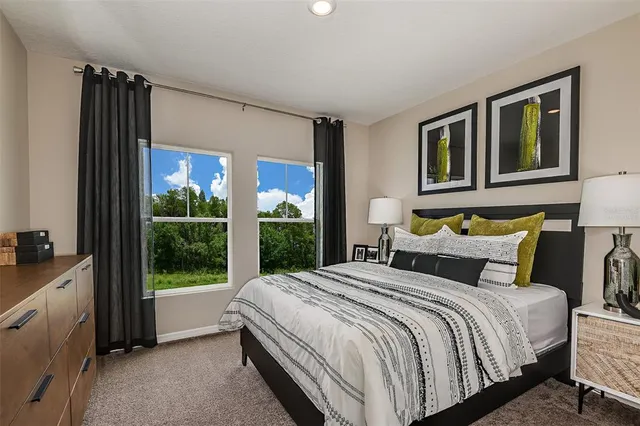 a bedroom with a large bed and a large window