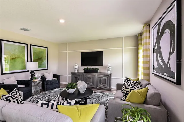 a living room with furniture and a flat screen tv