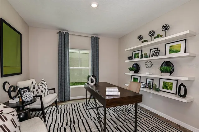 a living room with furniture and a book shelf