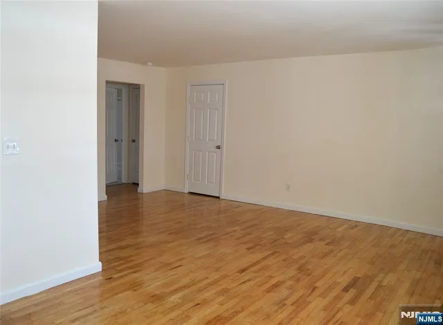 a view of an empty room and wooden floor