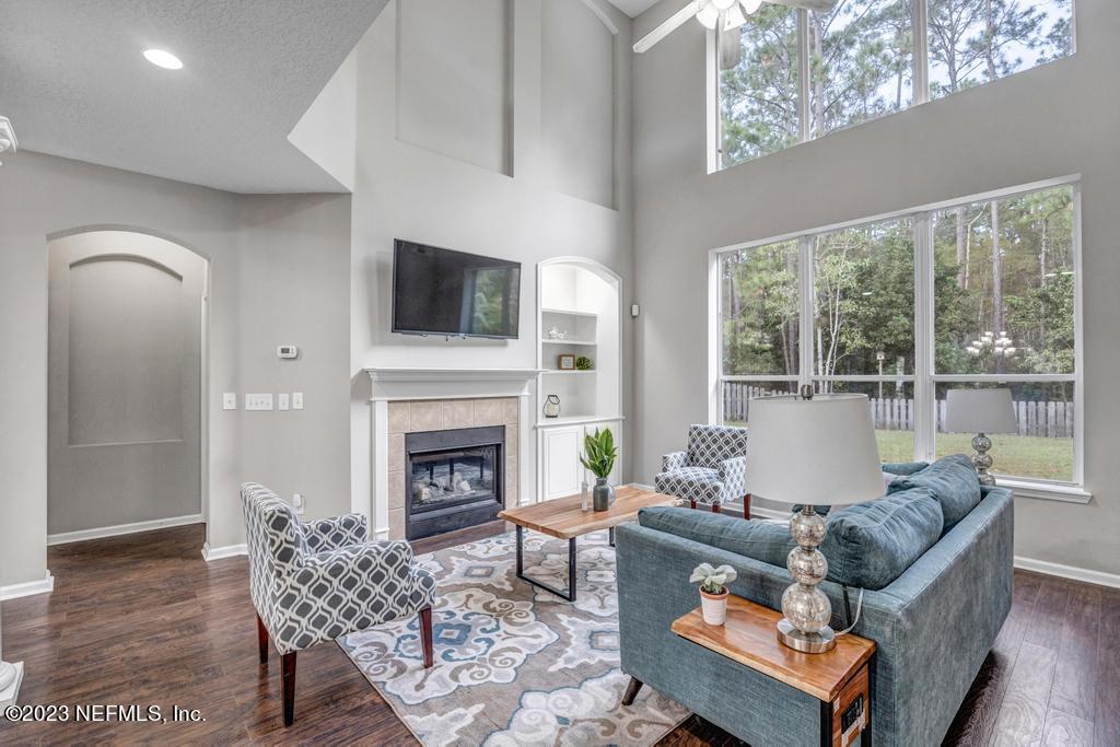 428 Sparrow Branch Circle St. Johns, FL 32259 - Photo 12 of 42 a living room with furniture a fireplace and a flat screen tv