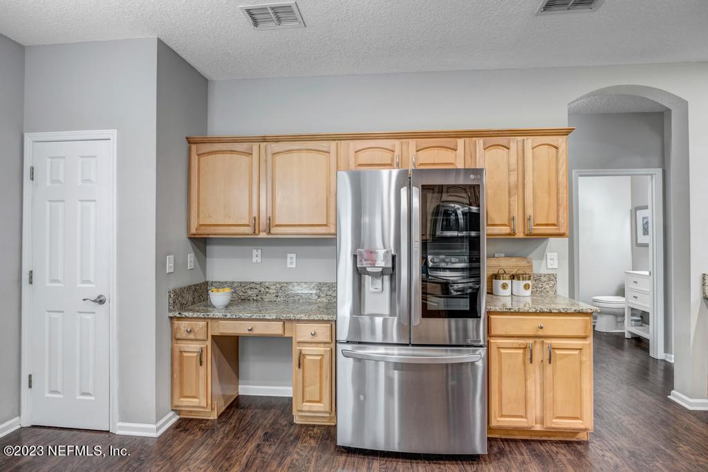 428 Sparrow Branch Circle St. Johns, FL 32259 - Photo 18 of 42 a kitchen with stainless steel appliances granite countertop a refrigerator and a stove top oven
