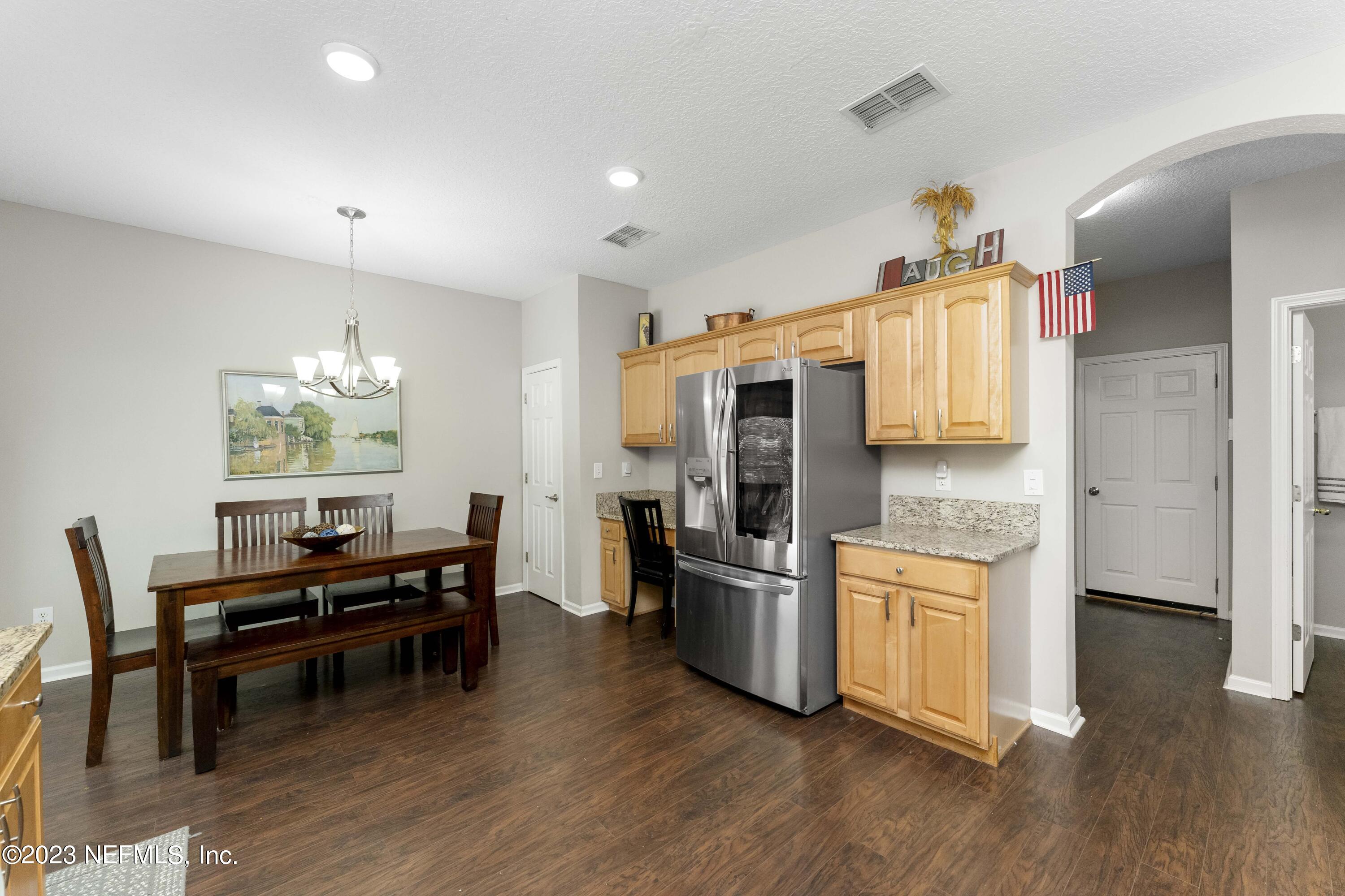 428 Sparrow Branch Circle St. Johns, FL 32259 - Photo 19 of 42 a kitchen with stainless steel appliances wooden floor and dining table