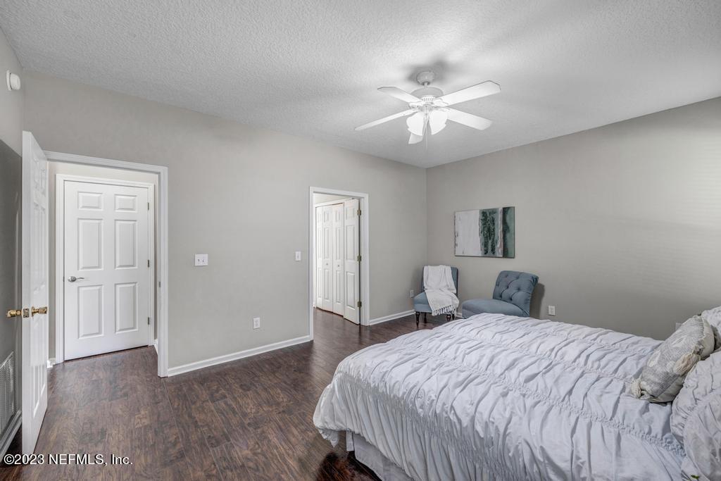 428 Sparrow Branch Circle St. Johns, FL 32259 - Photo 23 of 42 a bedroom with a large bed and a chandelier