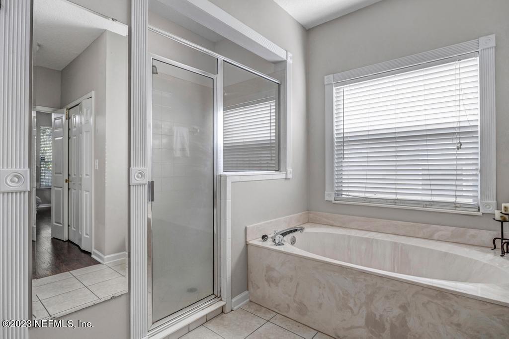428 Sparrow Branch Circle St. Johns, FL 32259 - Photo 26 of 42 a bathroom with a bathtub and a shower
