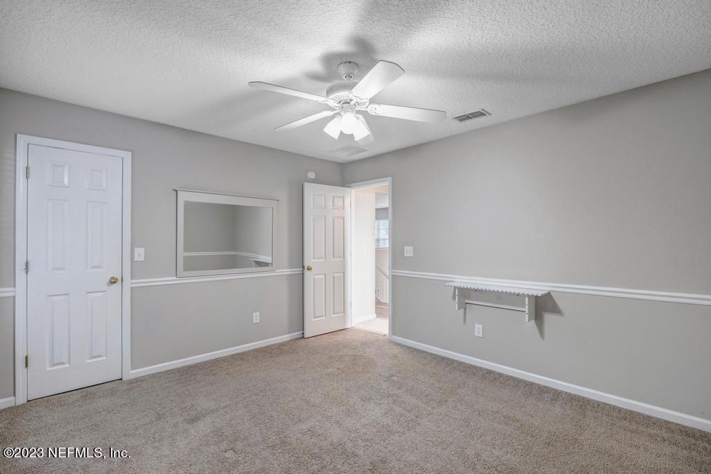 428 Sparrow Branch Circle St. Johns, FL 32259 - Photo 30 of 42 an empty room with closet and fan