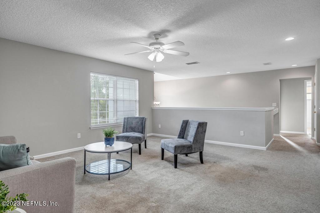 428 Sparrow Branch Circle St. Johns, FL 32259 - Photo 34 of 42 a living room with furniture and a ceiling fan