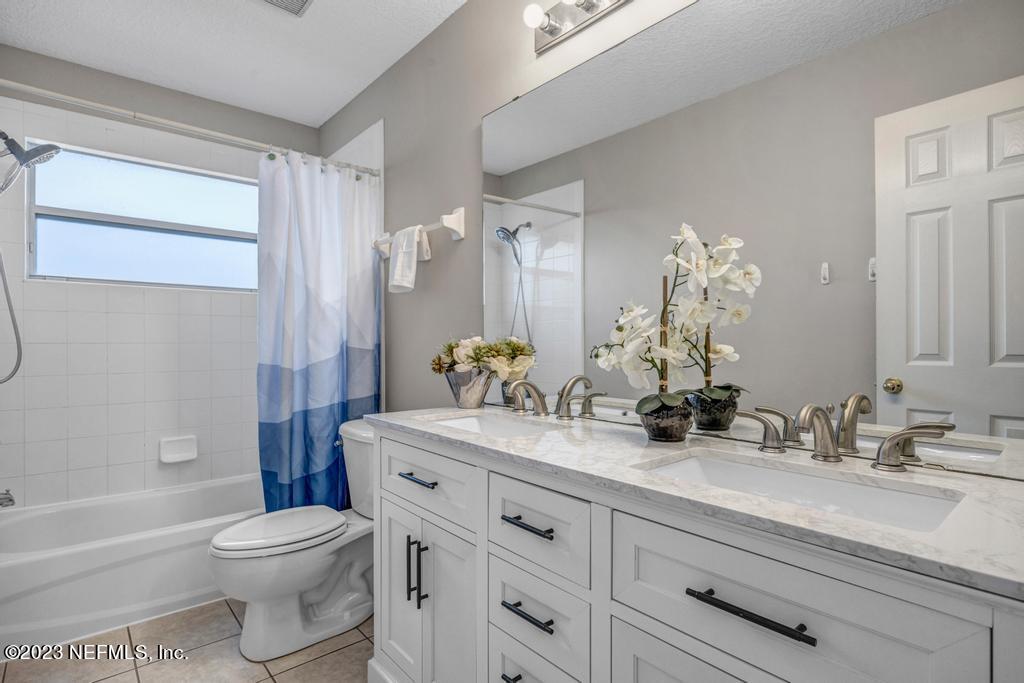 428 Sparrow Branch Circle St. Johns, FL 32259 - Photo 37 of 42 a bathroom with a double vanity sink toilet and shower