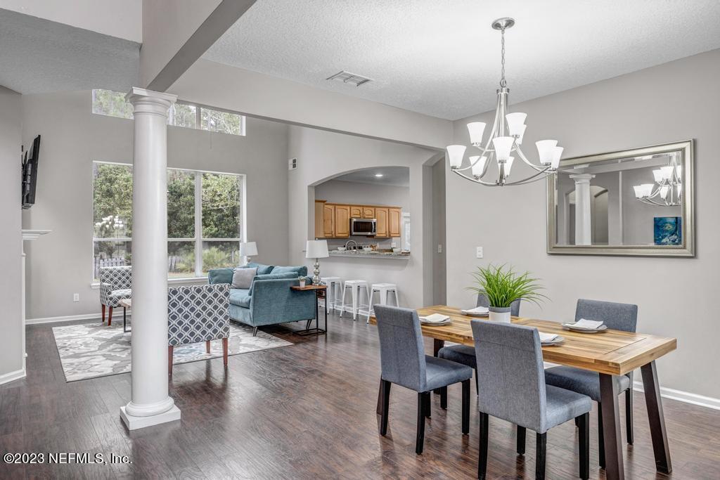 428 Sparrow Branch Circle St. Johns, FL 32259 - Photo 8 of 42 a view of a dining room with furniture wooden floor and chandelier