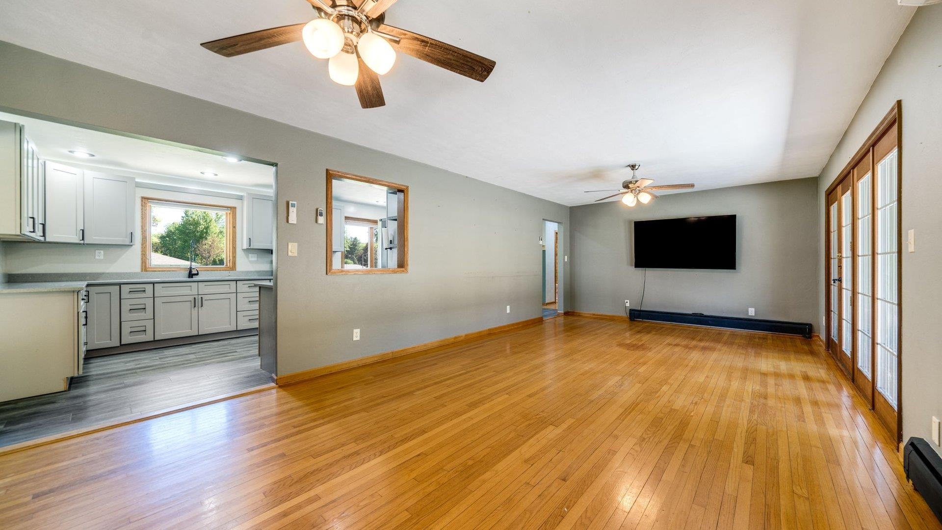 313 West Margaret Fuller Road Oregon, IL 61061 - Photo 10 of 46 a view of an empty room with window and wooden floor