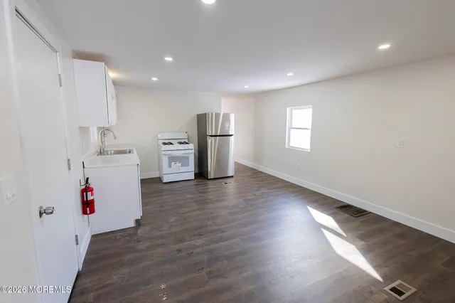 a room with furniture and white walls