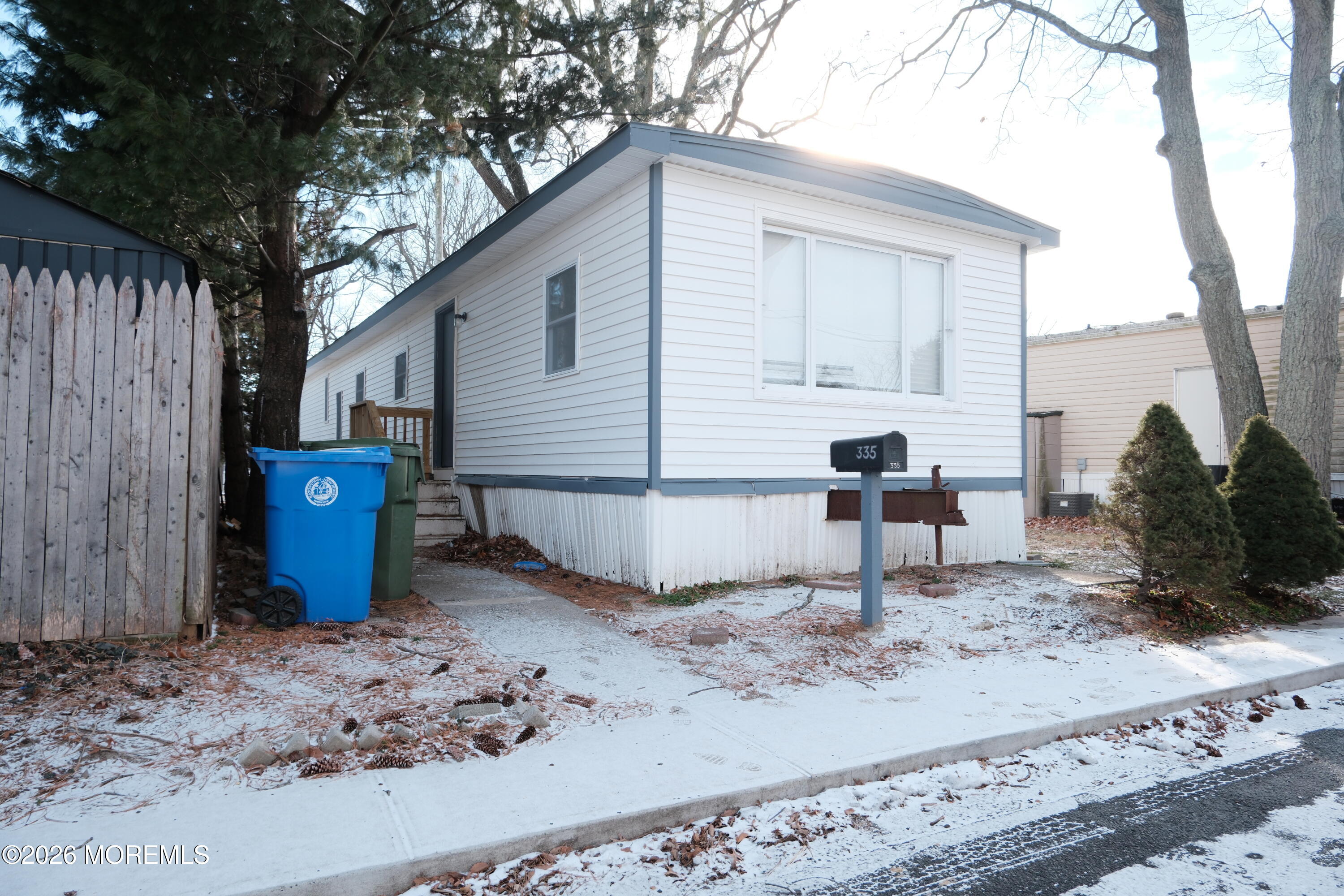 335 Adams Street Eatontown, NJ 07724 - Photo 7 of 7 a view of a backyard with table and chairs and a large tree