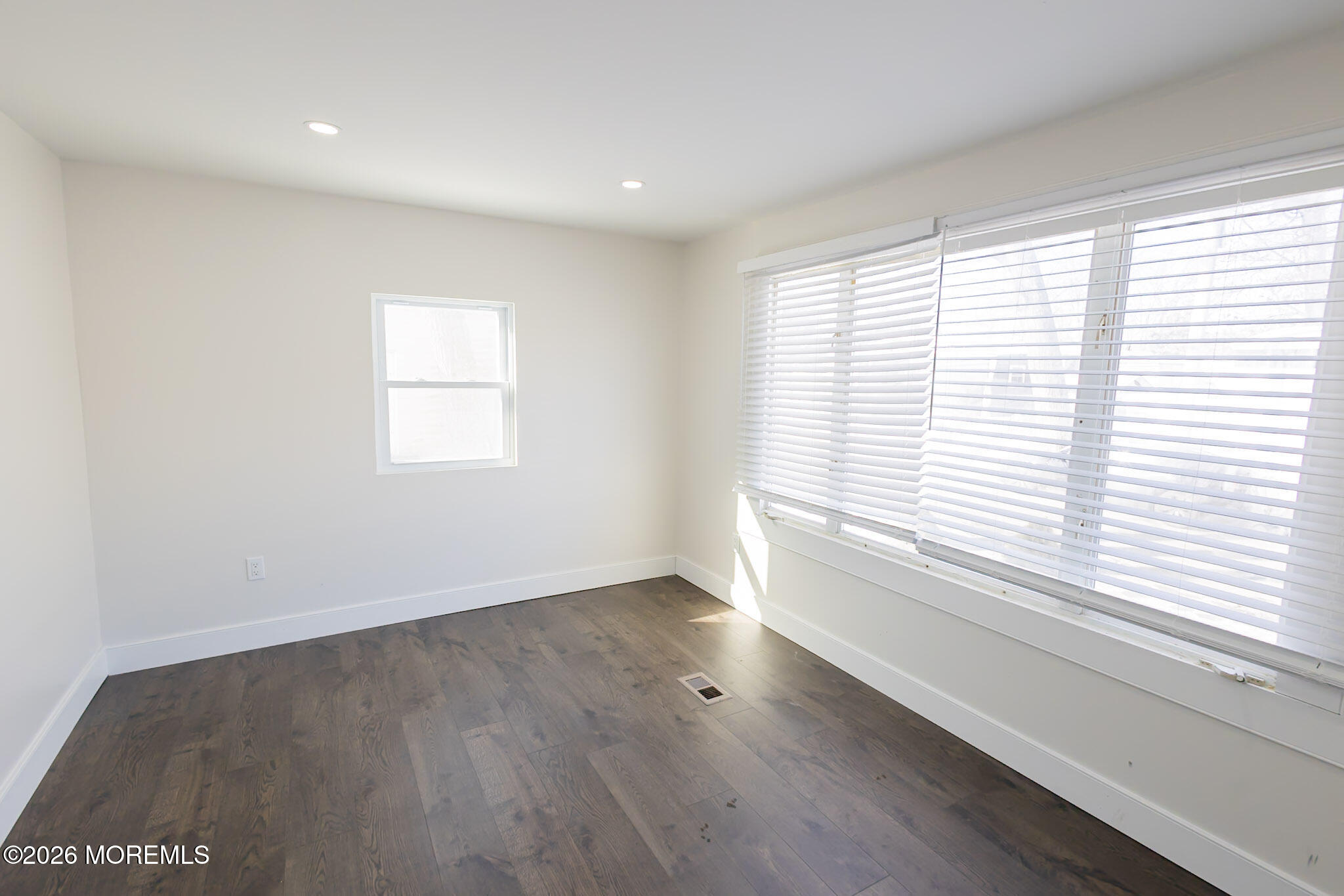 335 Adams Street Eatontown, NJ 07724 - Photo 7 of 10 an empty room with wooden floor and windows