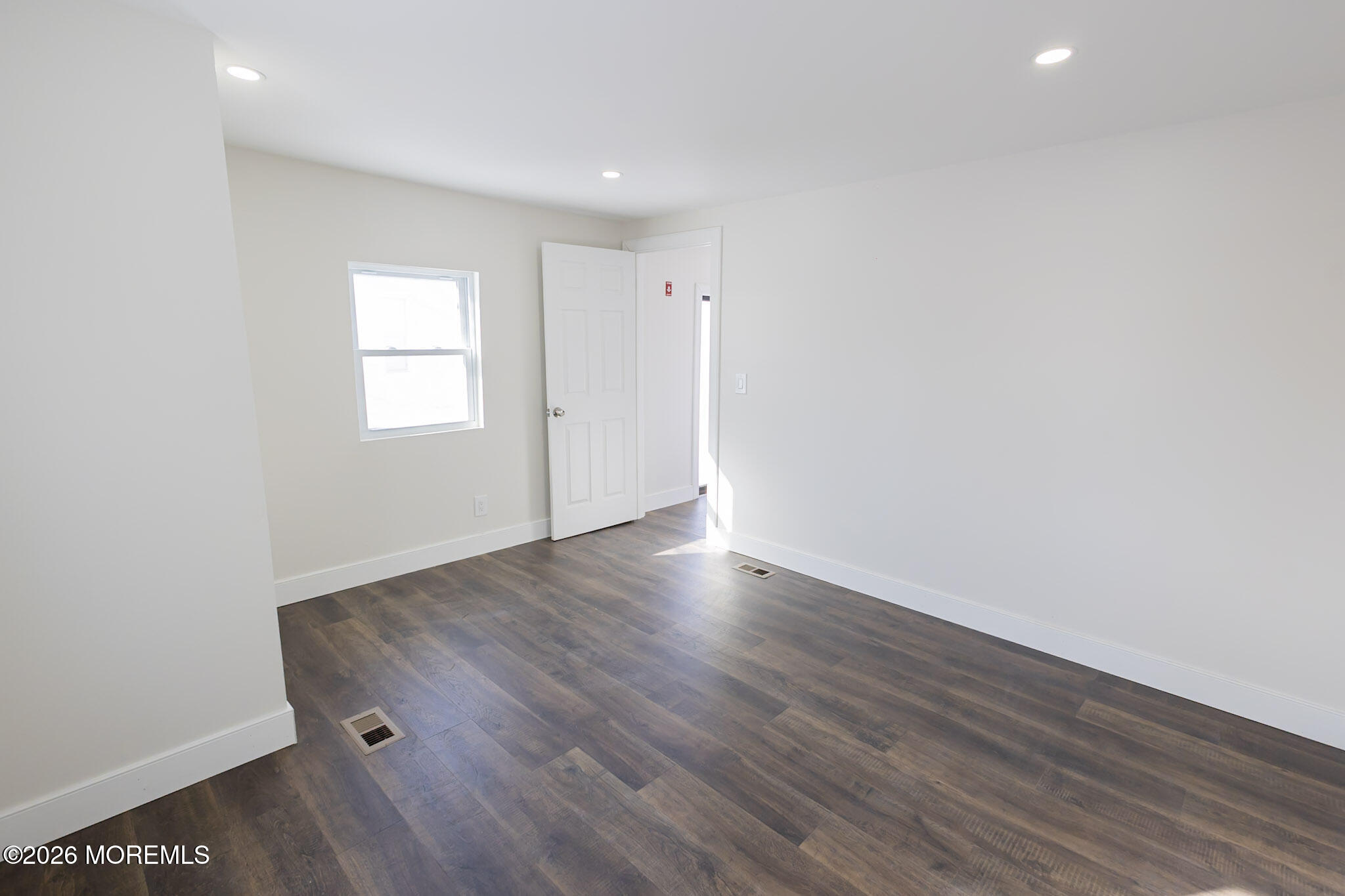 335 Adams Street Eatontown, NJ 07724 - Photo 9 of 10 an empty room with wooden floor and windows
