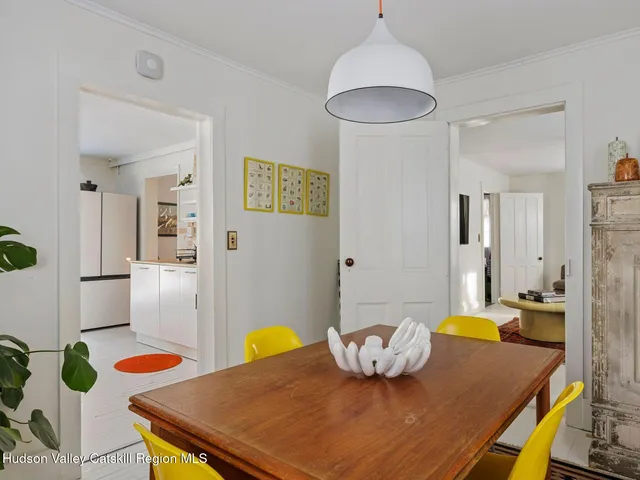 a kitchen with stainless steel appliances a sink a microwave a refrigerator and cabinets