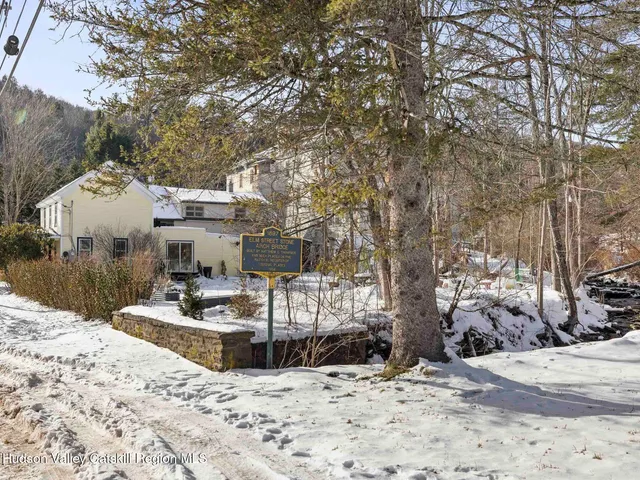 a view of a house with snow on the road