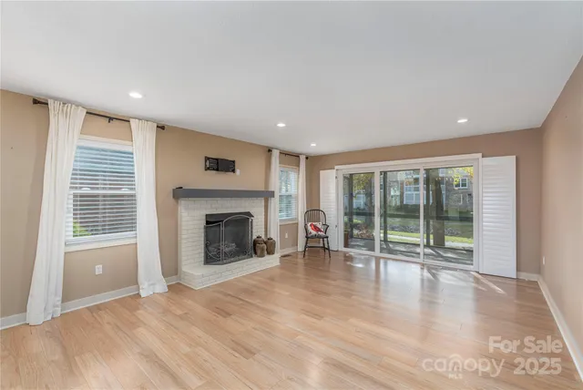 wooden floor fireplace and natural light in room