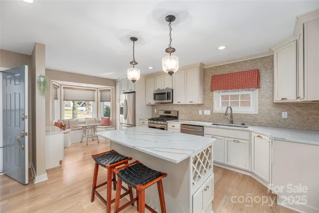 a kitchen with a table chairs stove and cabinets