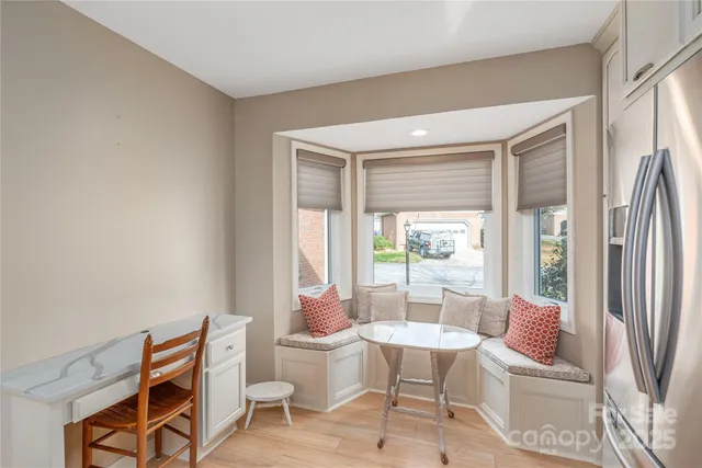 a living room with furniture a fireplace and a floor to ceiling window