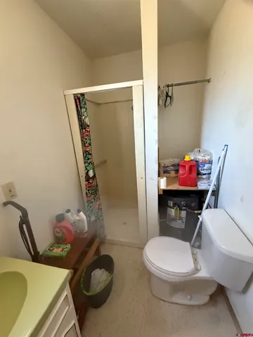 a room with gym equipment and wooden floor