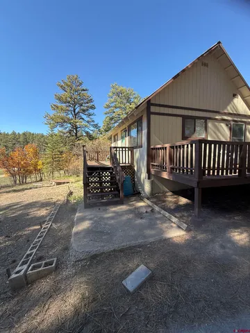 a view of a wooden deck with a yard