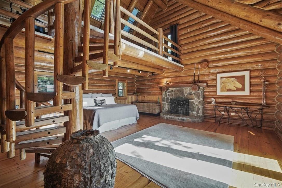 101 Mountain Lodge Road Washingtonville, NY 10992 - Photo 11 of 26 First floor extensive primary suite with woodturning fireplace, walk-in closets and loft accessed by a charming spiral staircase