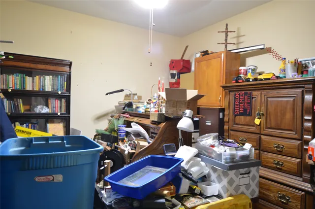 a bed sitting in a bedroom next to a window and a bathroom