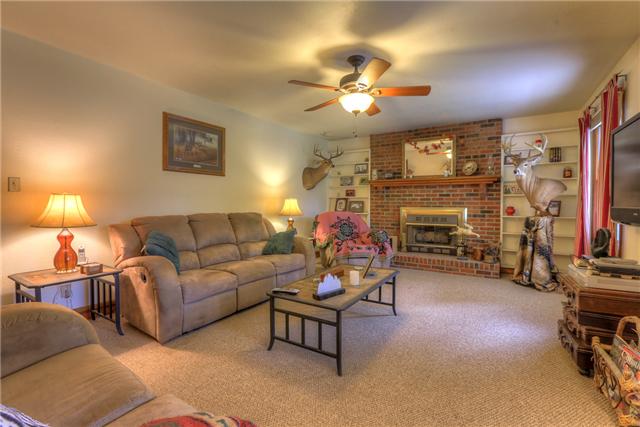 550 Puncheon Creek Road Lafayette, TN 37083 - Photo 3 of 20 Step into your spacious living room! Take a look at the built in shelving on each side of the brick fireplace!