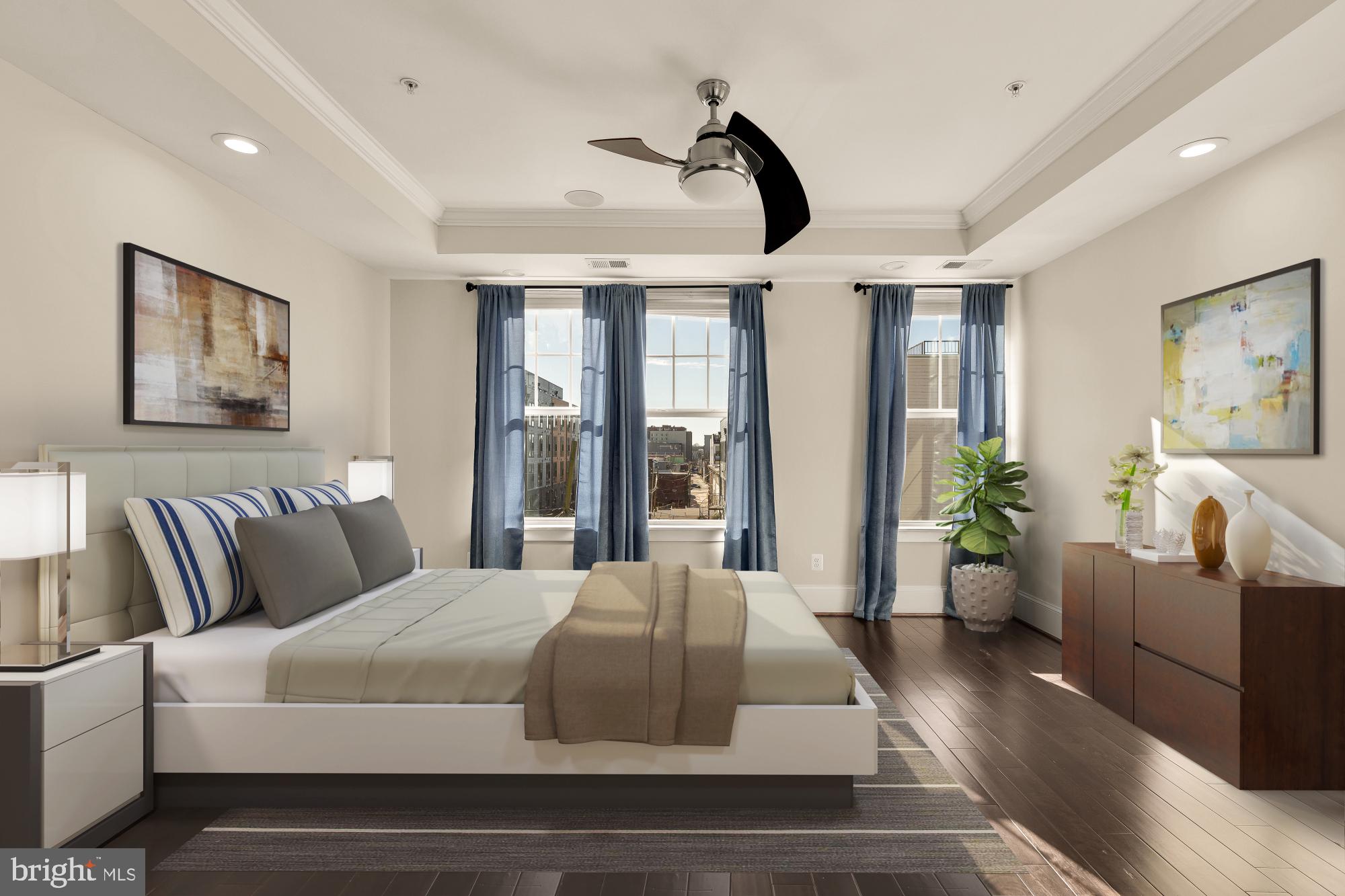 a bedroom with a large bed and a large window