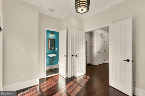 an entryway at a room with wooden floor