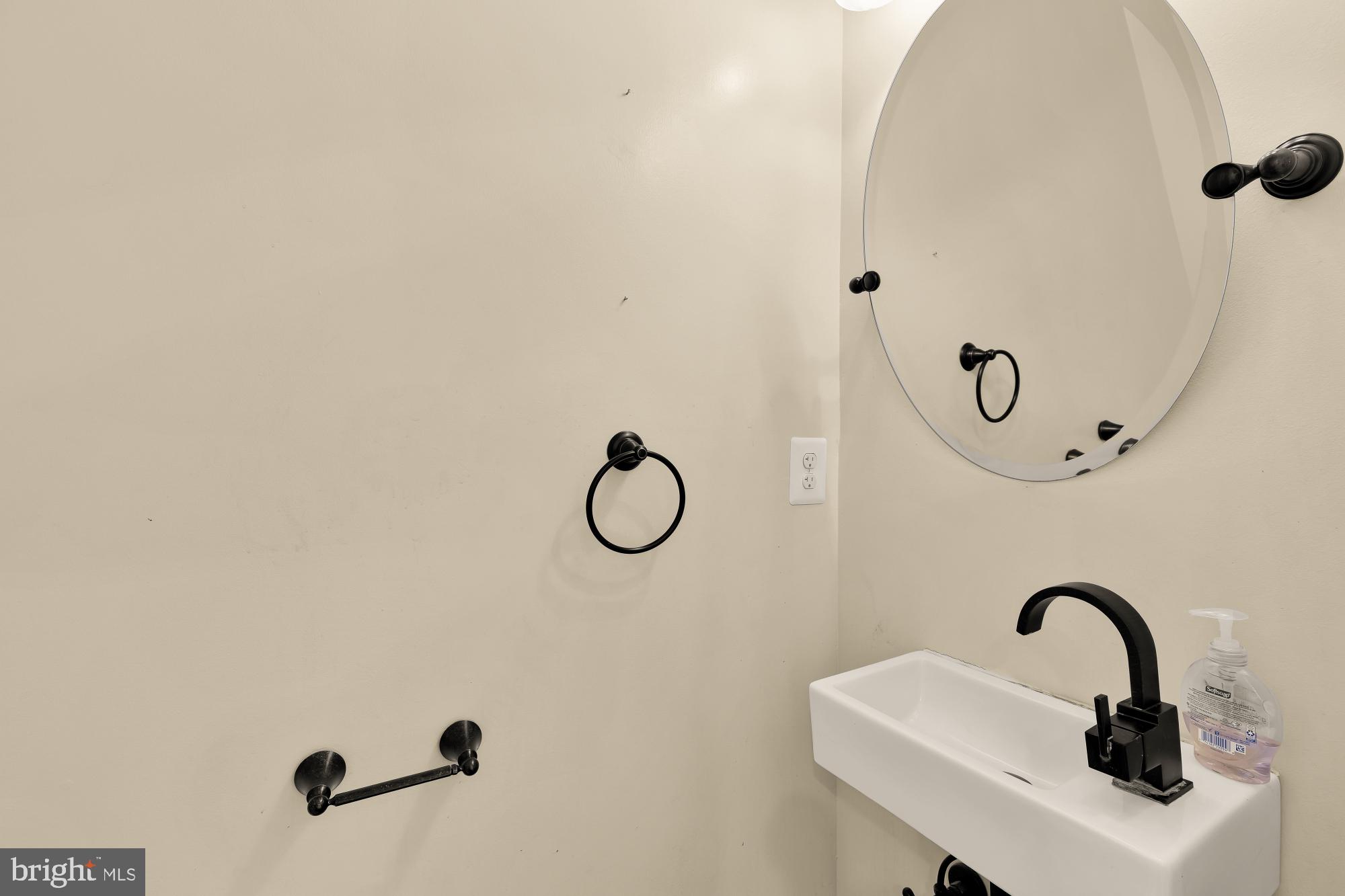 1609 Levis Street Northeast Washington, DC 20002 - Photo 16 of 35 a bathroom with a sink and mirror