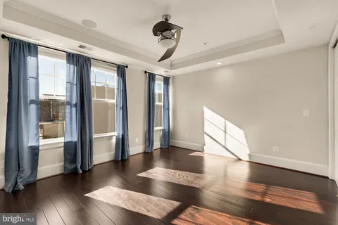 a view of a hallway with wooden floor and glass door