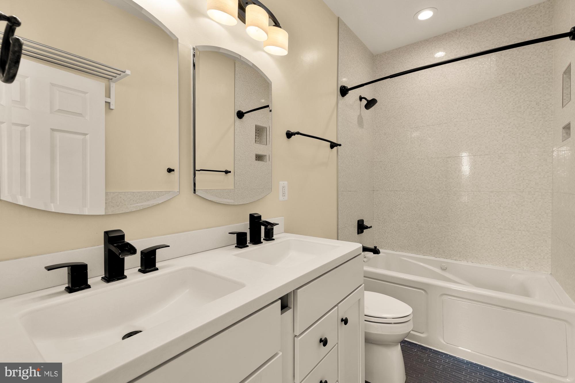 1609 Levis Street Northeast Washington, DC 20002 - Photo 19 of 35 a bathroom with a sink a toilet and a bathtub
