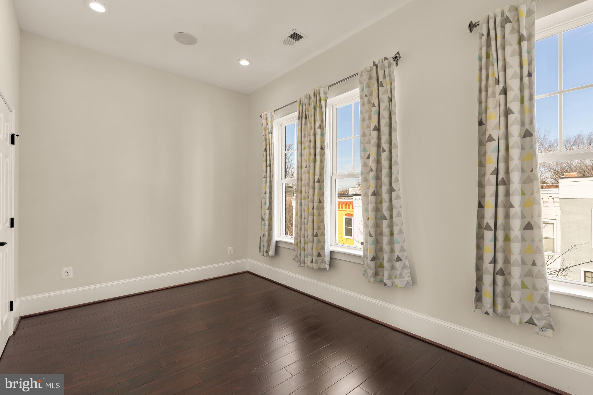 1609 Levis Street Northeast Washington, DC 20002 - Photo 24 of 35 a view of an empty room with wooden floor and a window