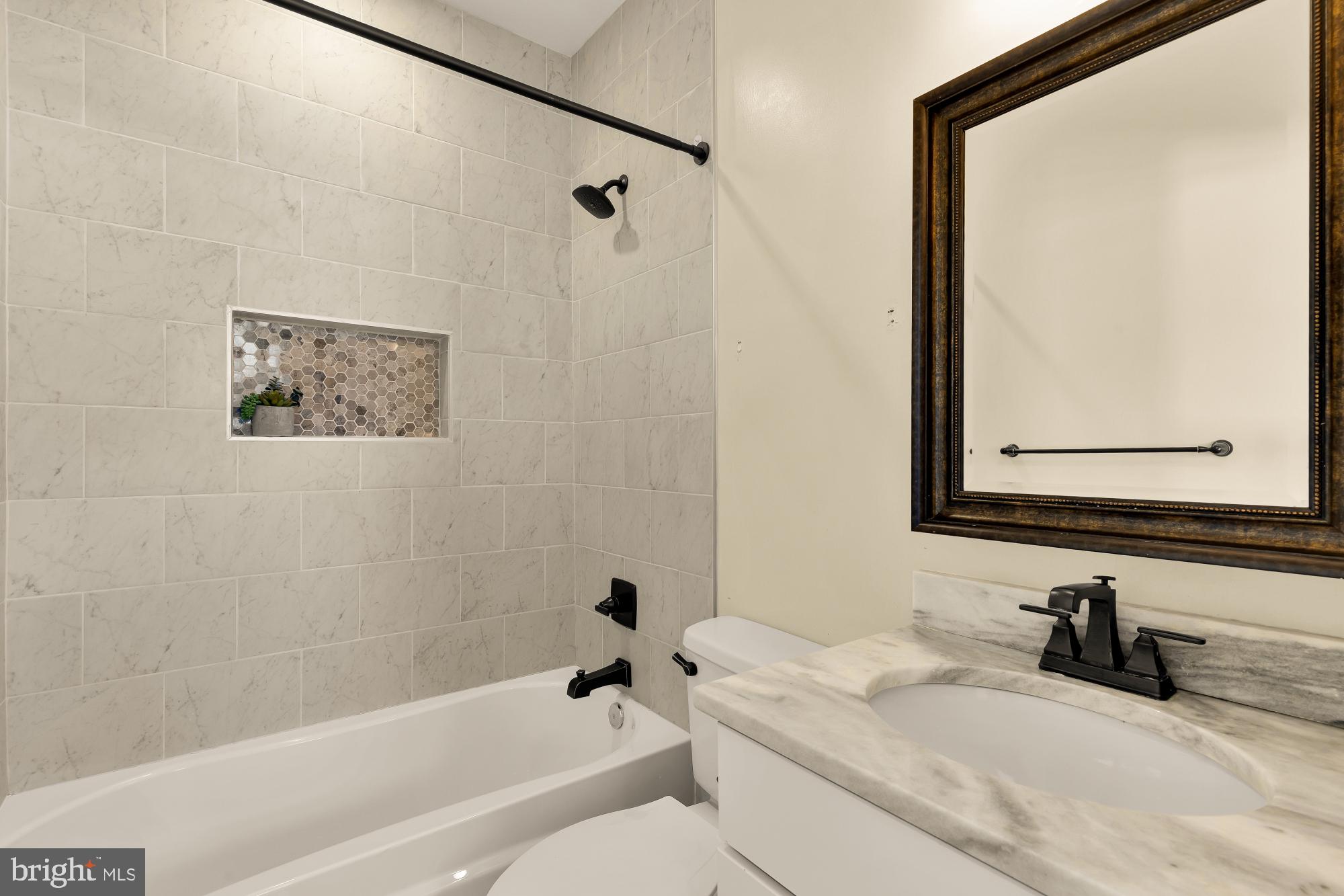 1609 Levis Street Northeast Washington, DC 20002 - Photo 25 of 35 a bathroom with a granite countertop sink mirror vanity and toilet
