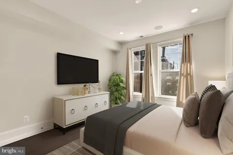 a bedroom with a bed and a flat screen tv
