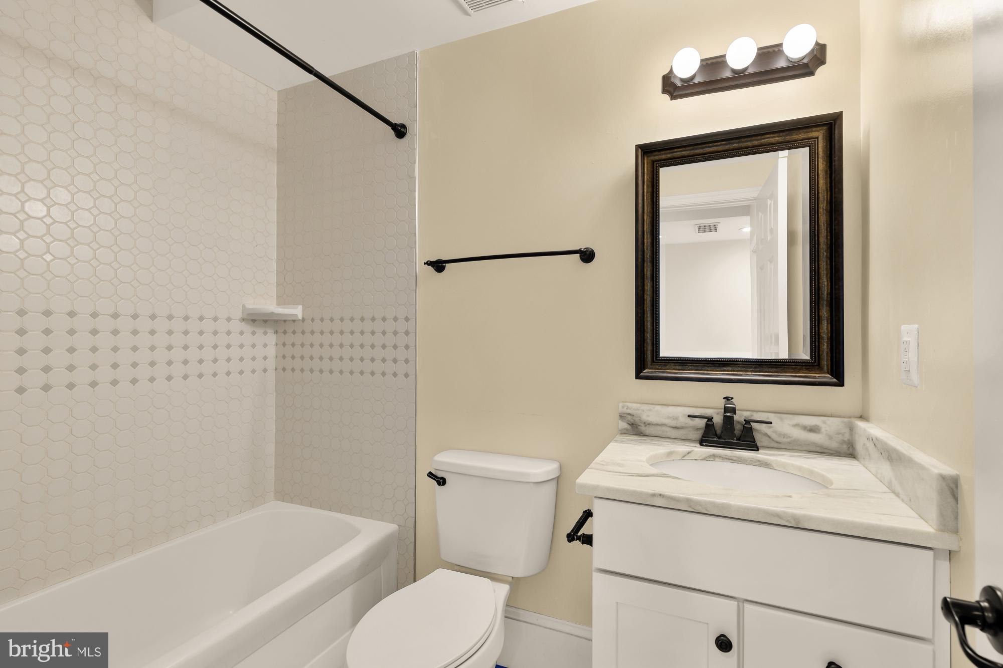 1609 Levis Street Northeast Washington, DC 20002 - Photo 30 of 35 a bathroom with a granite countertop sink toilet and shower