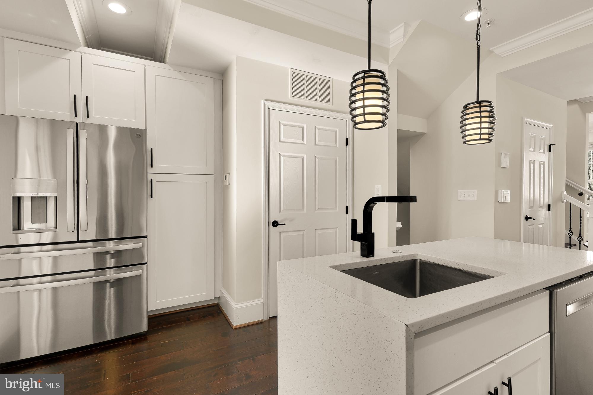 1609 Levis Street Northeast Washington, DC 20002 - Photo 7 of 35 a kitchen with granite countertop a sink a counter space appliances and cabinets